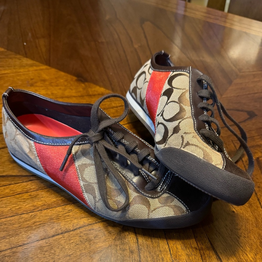 Coach monogram canvas shoe with orange stripe and leather detail.